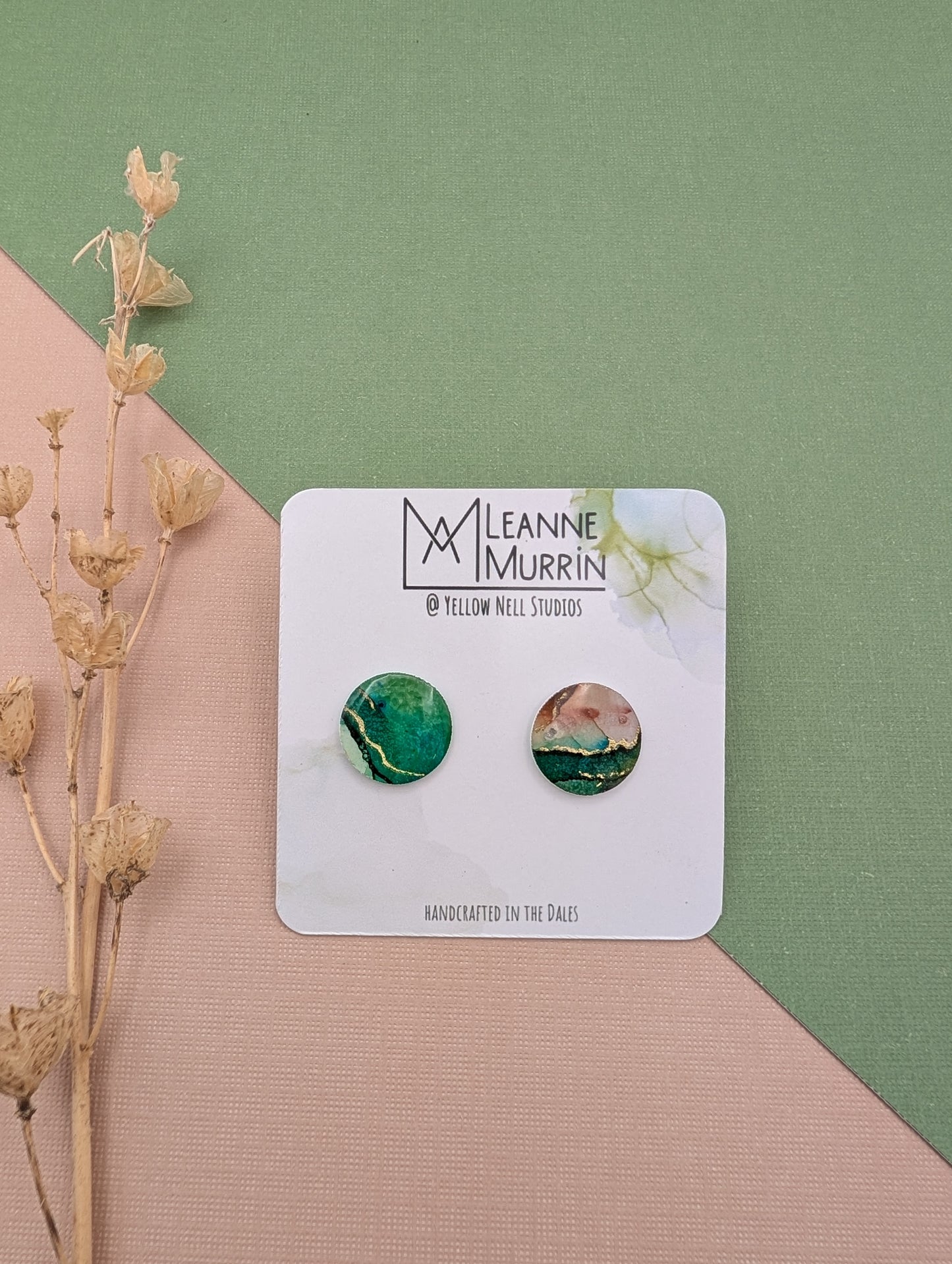 Pair of earrings on a Leanne Murrin branded card with a green and beige background