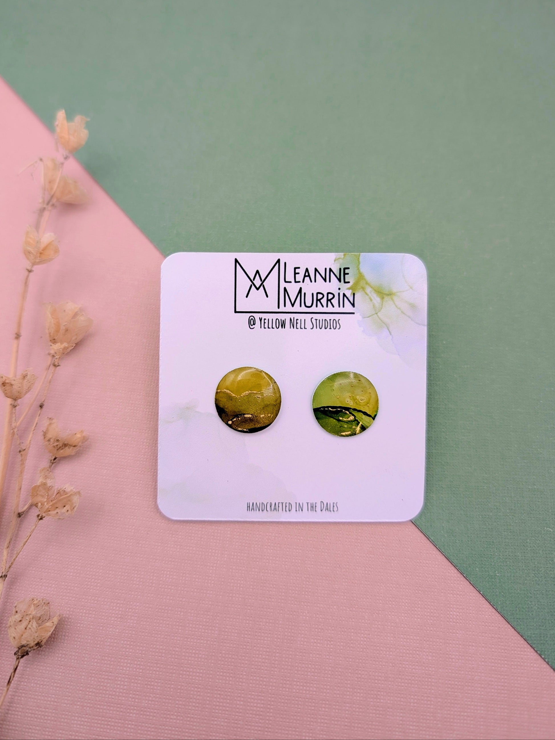 Pair of green earrings on a Leanne Murrin branded card with a pink and green background.